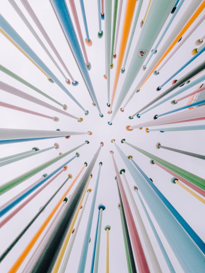 A vibrant array of vertical poles creates a fascinating diminishing perspective viewed from below.