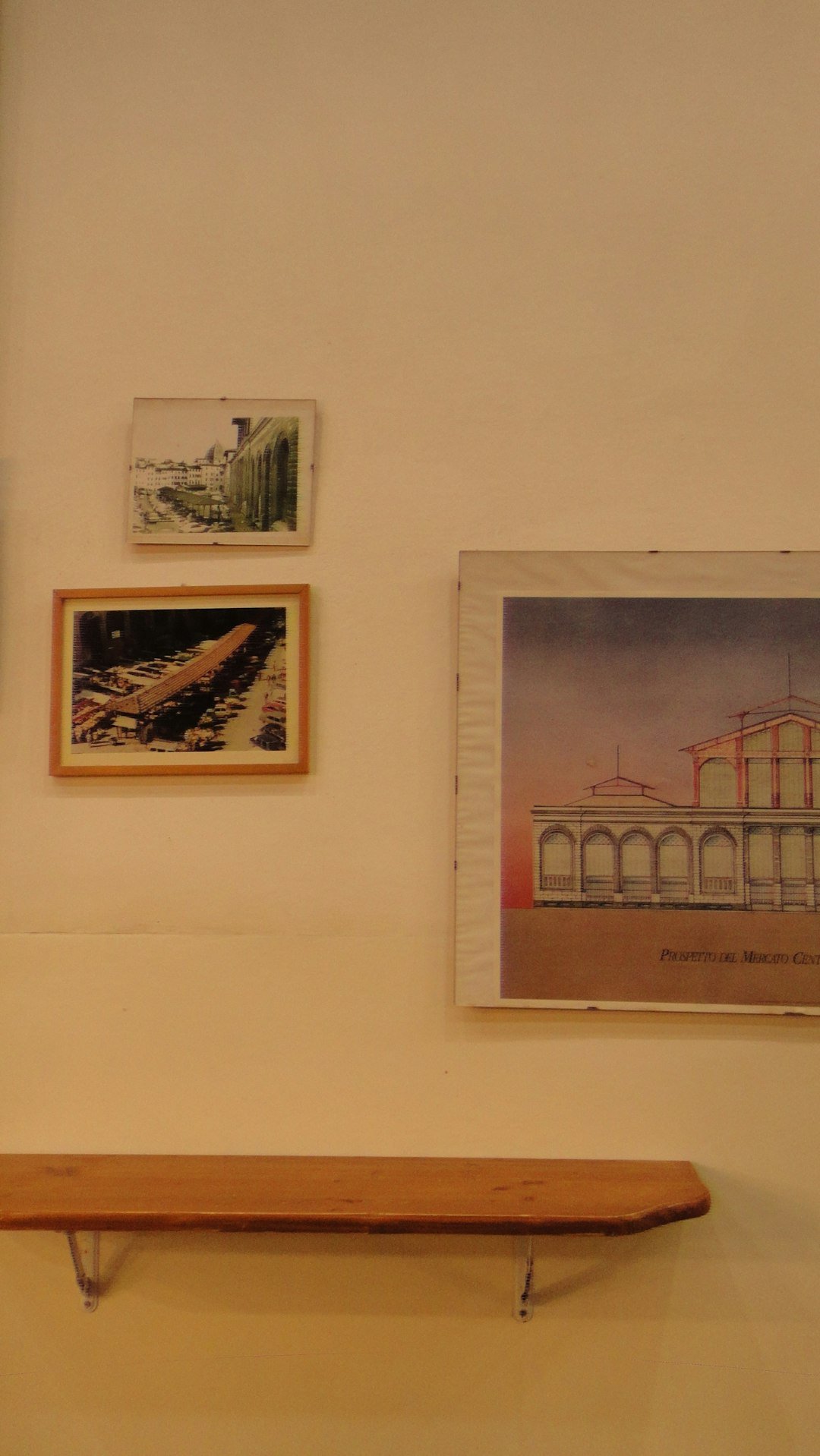 pictures-hang-above-a-wooden-bench-on-the-wall-6adt5uwfpry